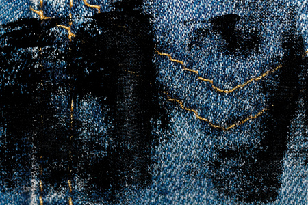 Grunge dirty Closeup of obsolete blue jeans pocket Denim texture, macro background for web site or mobile devices.の写真素材