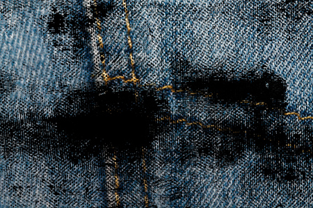 Dirty grunge Closeup of obsolete blue jeans pocket Denim texture, macro background for web site or mobile devices.の写真素材