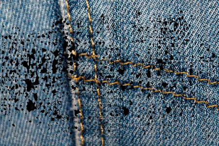 Dirty grunge Closeup of obsolete blue jeans pocket Denim texture, macro background for web site or mobile devices.の写真素材