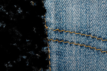 Dirty grunge Closeup of obsolete blue jeans pocket Denim texture, macro background for web site or mobile devices.の写真素材