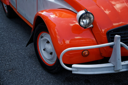 Headlamp of red vintage car, business concept