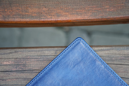 Notebook on bench in park, business concept.の写真素材