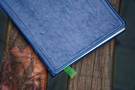 Notebook on bench in park, business concept.