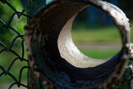 Steel mesh with metal rusty pipe, defocused background for web site or mobile devices.の写真素材