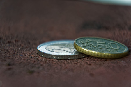 Business concept, macro Two euro coin and 50 cents.
