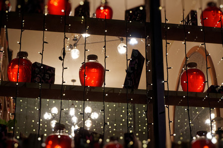 Interior of cozy pub or coffee shop or cafe with bottles and jars on shelves.