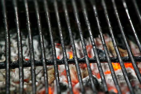 Heat charcoal under grid, street food preparation.