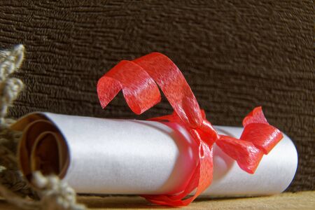 Rolled Kraft decorative paper, grunge page with red band.の写真素材