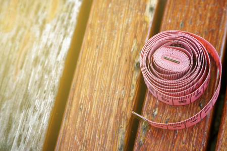 Fit centimeter on wooden bench measuring tape foe sport background.の写真素材