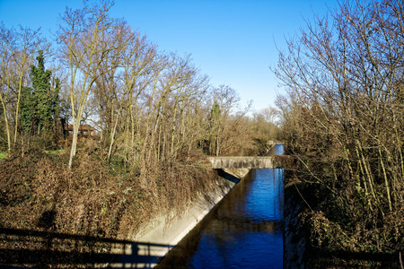 Water canal which is a source of natural water flowing from the mountains behind, Soft focus.の写真素材