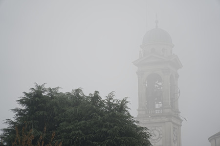 Cathedral Church bell tower in fog, gothic style.