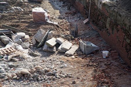 Construction Site damaged wall repairing, construction machinery, bulldozer, excavation factoryのeditorial素材