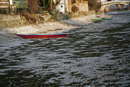 River drought, red boat without water due global warming.の写真素材