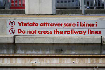 Do not cross the railway lines - Warning sign in train station.の写真素材