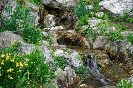 Flowing water stream, water drops and reflection.の写真素材