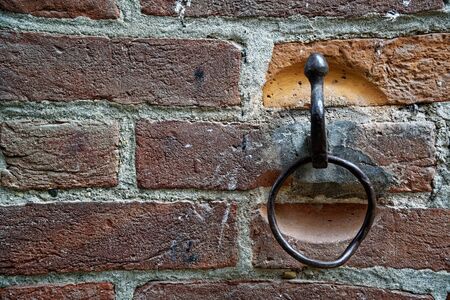 Blocker Tie Ring for horse, Ornate iron horse tie ring on the facade of medieval castle, Torino, Italyの写真素材