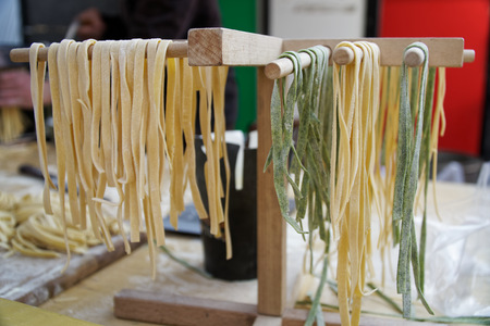 Homemade pasta - Closeup of process of making cooking. Chef make fresh italian traditional pasta.の写真素材