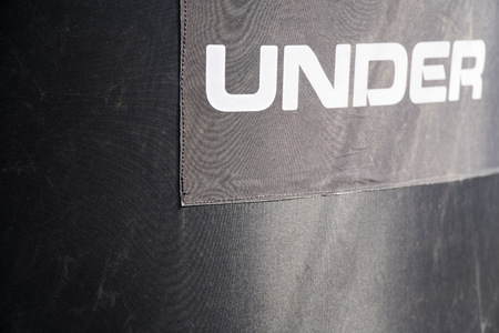 Black rubber background with white text - Under.の写真素材