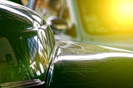 Polished car body with light reflection, sunny bunny on old vintage car, business consept.の写真素材