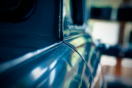 Polished car body with light reflection, sunny bunny on old vintage car, business consept.の写真素材