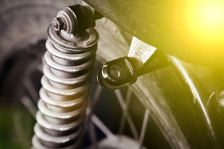 Old classic part of retro motocycle, close-up shock absorber.の写真素材