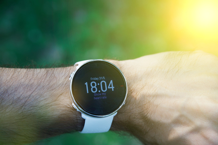 Athlete runner checking cardio or current heart rate on sports smartwatchの写真素材