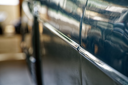 Polished car body with light reflection, sunny bunny on old vintage car, business consept.の写真素材