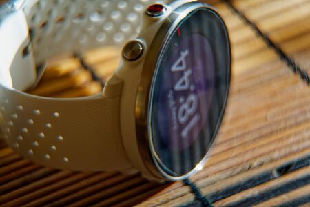 Sport watch in white color on wooden table, Smart watch for running and fitness trainingの写真素材