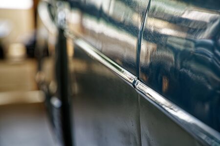 Polished car body with light reflection, sunny bunny on old vintage car, business consept.の写真素材