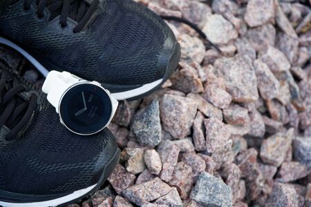 Sport watch for crossfit and triathlon on the running shoes. Smart watch for tracking daily activity and strength trainingの写真素材