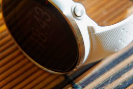 Sport watch in white color on wooden table, Smart watch for running and fitness trainingの写真素材
