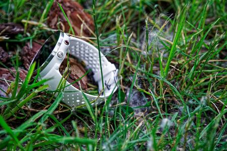 Sport watch for running white color on the ground in the grass. Fitness watch for tracking daily activity and strength trainingの写真素材