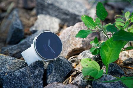 Sport watch for triathlon on the granite gravel. Smart watch for tracking daily activity and strength trainingの写真素材