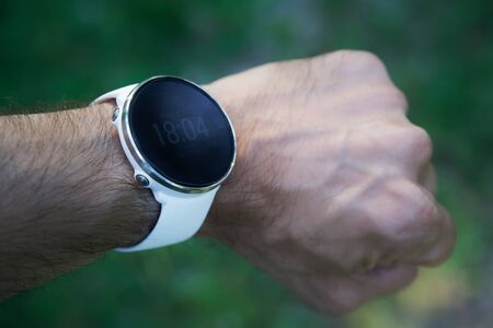 Athlete runner checking cardio or current heart rate on sports smartwatchの写真素材