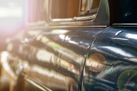 Polished car body with light reflection, sunny bunny on old vintage car, business consept.の写真素材