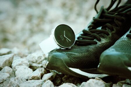 Sport watch for crossfit and triathlon on the running shoes. Smart watch for tracking daily activity and strength trainingの写真素材