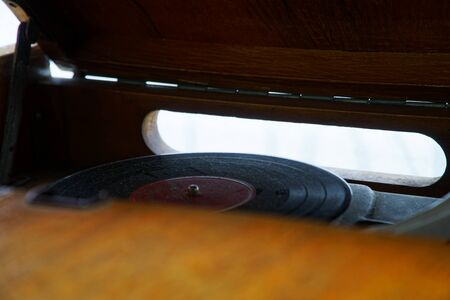 Turntable, Old record player stylus on a rotating disc, vintage filtered, selective focus.の写真素材