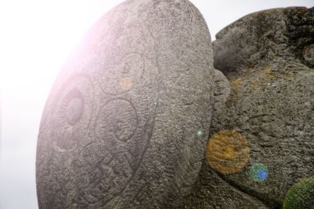Carved stone - ancient inscription and nature lines ornate.の写真素材