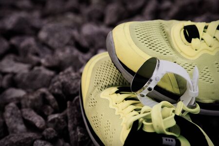 Sport watch for crossfit and triathlon on the yellow running shoes. Smart watch for tracking daily activity and strength trainingの写真素材