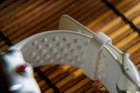 Sport watch in white color on wooden table, Smart watch for running and fitness trainingの写真素材