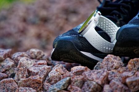 Sport watch for crossfit and triathlon on the running shoes. Smart watch for tracking daily activity and strength trainingの写真素材