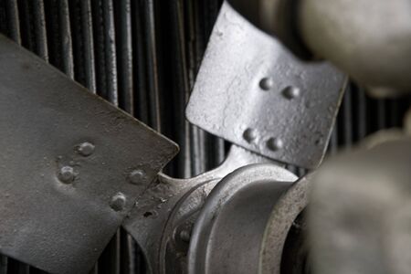 Vintage antique automotive tractor rusty fan blade and belt behind the radiator with pulleys showingの写真素材