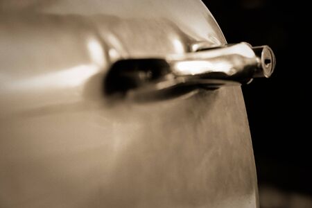 Edge door of car Door handle of retro classic car, Vintage tone.の写真素材