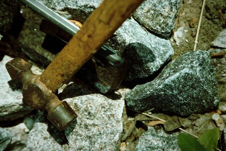 Smartphone broken glass with hammer on gravel stones. Selective focus.の写真素材