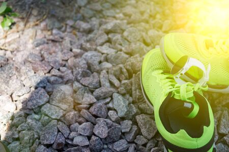Sport watch for crossfit and triathlon on the yellow running shoes. Smart watch for tracking daily activity and strength training. Sun beam lights.の写真素材