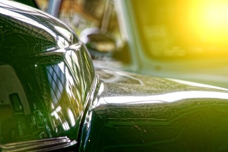 Polished car body with light reflection, sunny bunny on old vintage car, business consept.の写真素材