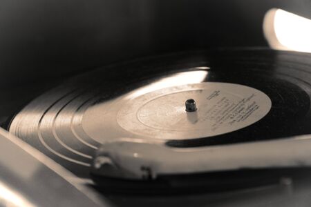 Turntable, Old record player stylus on a rotating disc, vintage filtered, selective focus.の写真素材