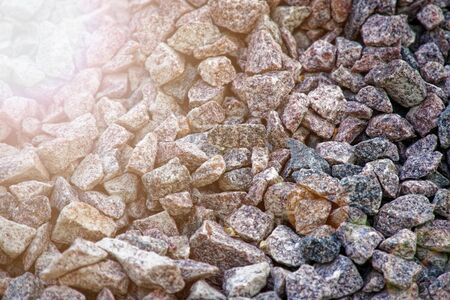 Road gravel and granite gravel texture. Crushed Gravel background. Pile of Stones texture with sunbeam lights. Industrial coals.の写真素材