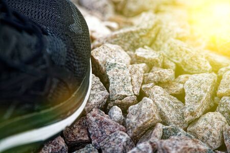 Running shoes before practice. Trail running shoes in a park, close-up sneakers. Sport active outdoor lifestyle concept. Horizontal photo banner for website header design. Sun beam lights.の写真素材