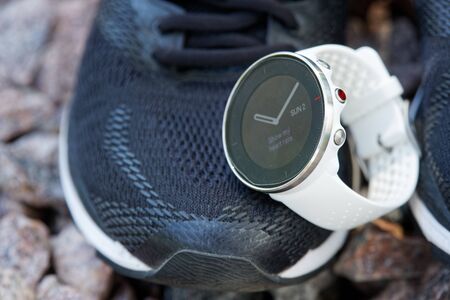 Sport watch for crossfit and triathlon on the running shoes. Smart watch for tracking daily activity and strength trainingの写真素材
